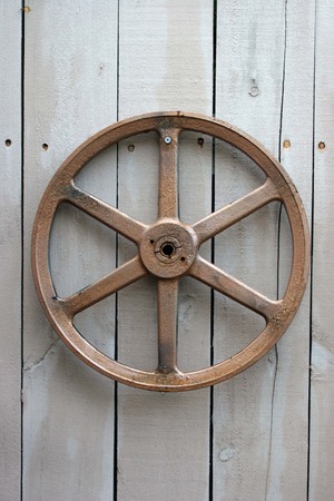 Rustic Metal Wheel  on Woodの写真素材
