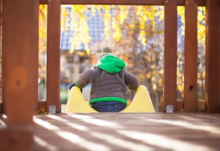 Children playing with autumn fallen leaves in park. Autumn fun, happy child.の写真素材
