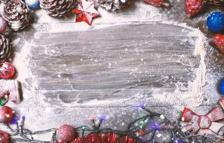 Christmas ornaments on the wooden background covered with snowの写真素材