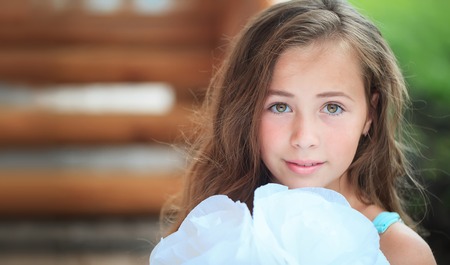 young girl on green grass bright summer dayの写真素材