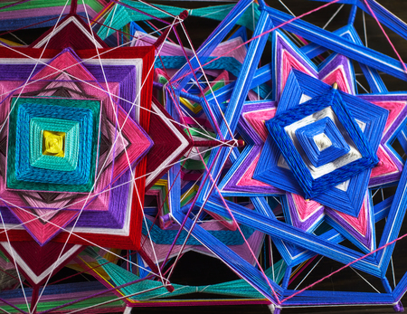 Knitted beautiful mandala. Two knitted tibetan mandala from threads, top view.