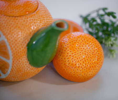 Ceramic teapot handmade orange with a gold leafの写真素材