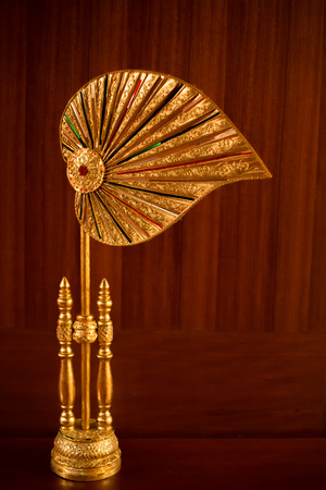 antique fan in front of wooden wallの写真素材