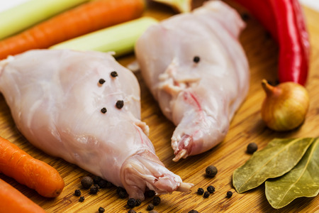 Some pieces of raw rabbit meat with vegetables and spicesの写真素材