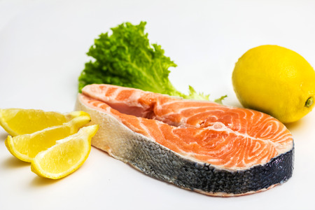 Raw Salmon Red Fish Steak with Herbs and Lemon isolated on Whiteの写真素材