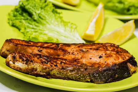 Grilled Salmon with Fresh Salad Leaf and lemonの写真素材