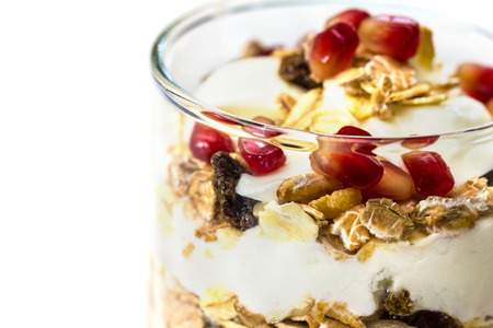 Glass of Muesli with fruits and yogurt isolated on whiteの写真素材