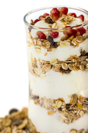 Glass of Muesli with fruits and yogurt isolated on whiteの写真素材