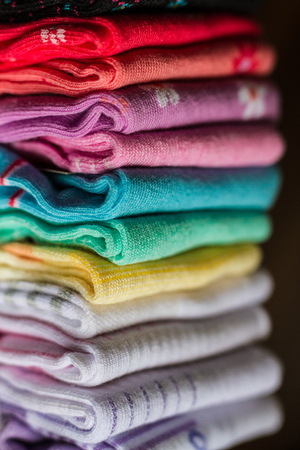 A pile of colorful clothes on whiteの写真素材