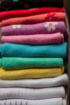 A pile of colorful clothes on whiteの写真素材