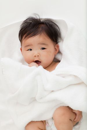 A baby looks surprised with joy.の写真素材