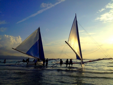 Sail boat by the sea at sunset