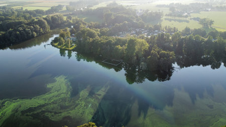 Aerial view of the lake and forest in the morning light.の写真素材