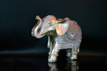 Elephant figurine on a black background, closeup of photoの写真素材