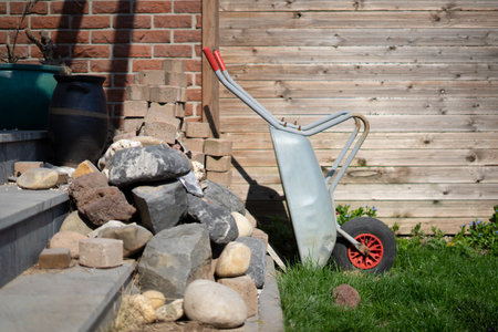 Garden tools in front of wooden wall with stones and bricks.の写真素材