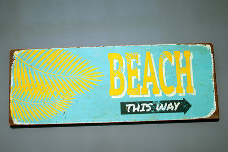 beach sign on the wall of the hotel, closeup of photoの写真素材