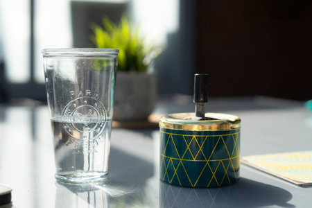 An ashtray and glass of water on the table.の写真素材