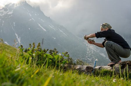 A man is doing laundry while campingの写真素材