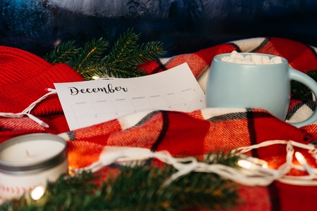 December Calendar with blank space. Christmas holiday mood concept. Hot coffee mug with marshmellow...