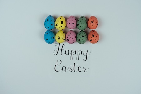 Beautiful painted Easter eggs and greeting card isolated on white background. Quail eggs. Happy Easter concept. Top viewの写真素材