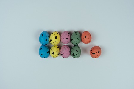 Multicolored Easter quail eggs isolated on pink background. Happy Easter and Spring concept. Top...