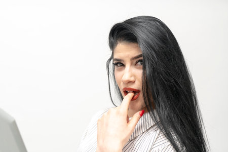 Young beautiful asian woman with long black hair and red manicure