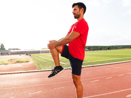 Athlete warming up by stretching before exercise. man doing stretching exercises before exercise