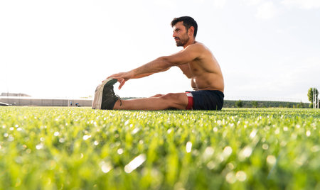 Athlete warming up by stretching before exercise