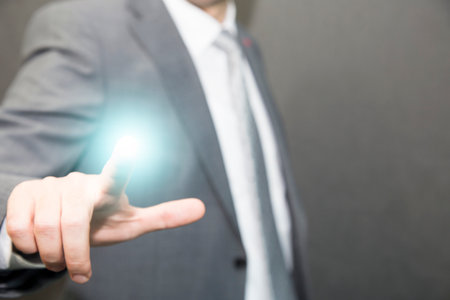 Close up of businessman touching digital screen with finger
