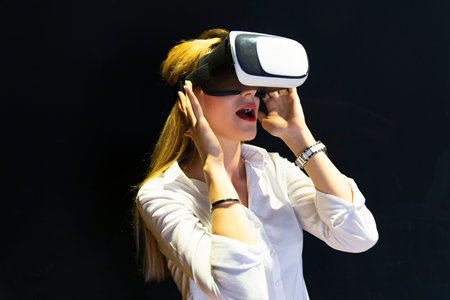 A woman is playing a video game with a virtual reality headset. Business woman wearing virtual...