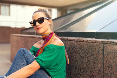 Portrait of beautiful young woman with sunglasses in the city