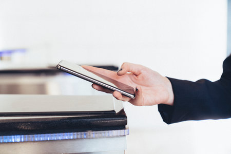 A person is using a cell phone to pay for something. Using the phone for secure passageの写真素材