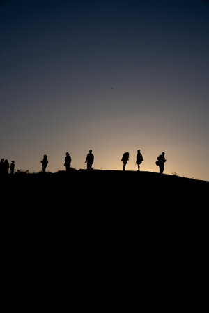 silhouettes of people on the hill. Silhouette People Sunriseの写真素材
