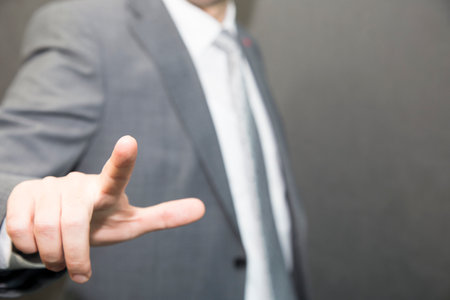 Businessman touching concepts in studio. Business Man pushing on a touch screen interfaceの写真素材