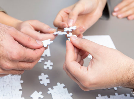 A group of people are working together to solve a jigsaw puzzle