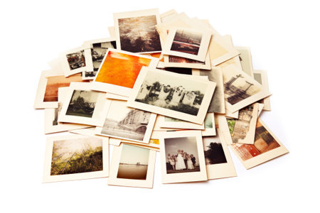 Pile of old photos isolated on white background. Retro style.の素材