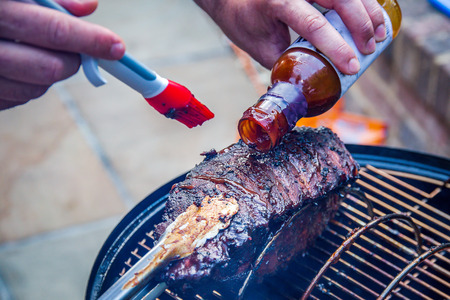 Cooking marinated baby back ribs on an outdoor barbecueの写真素材