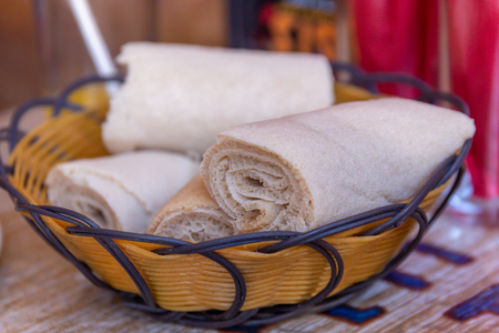 Rolls of Injera in a serving bowl.  Injera is a sourdough flatbread made from teff flour.  It is the national dish of Ethiopia, Eritrea, Somalia and Djiboutiの写真素材