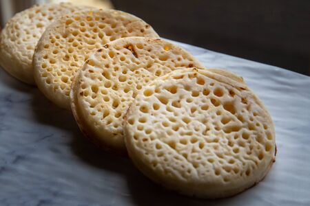 Hot toasted English crumpets arranged in a lineの写真素材