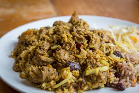 Jamaican Curried Goat served with traditional rice and peas