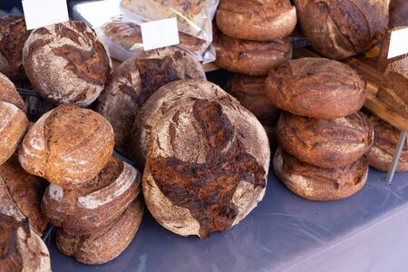 Freshly baked rustic rye granary bread on a food market stallの写真素材