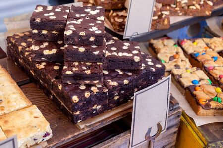 freshly baked slices of chocolate brownies on display on a market stall in the UKの写真素材