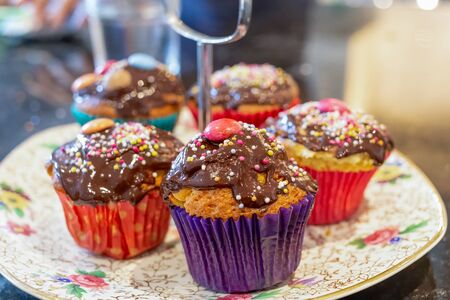 Chocolate covered cupcakes, with sprinkles on topの写真素材