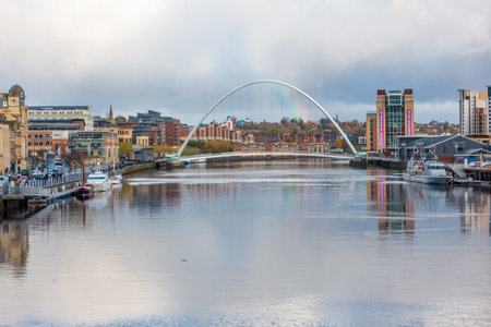 NEWCASTLE UPON TYNE, UK - NOVEMBER 08 2019: Rainbow behind Gateshead Millennium Bridge over the River Tyne, Newcastle, UKのeditorial素材