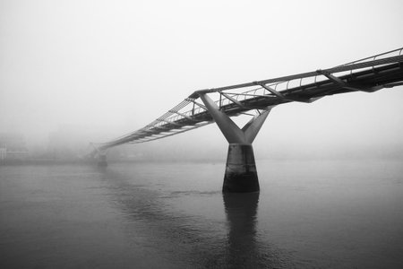Londons Millennium Bridge on a foggy morningの写真素材