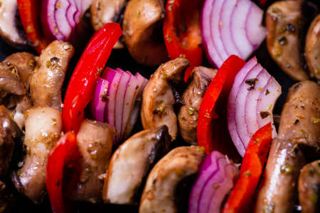 Close up of mushroom, red onion and red peppers kebabsの写真素材
