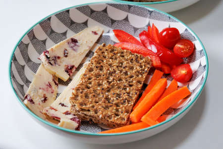 Healthy Rye crispbreads, vegetables and cheese in a bowlの写真素材