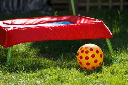 Childs trampoline and ball in a home garden settingの写真素材