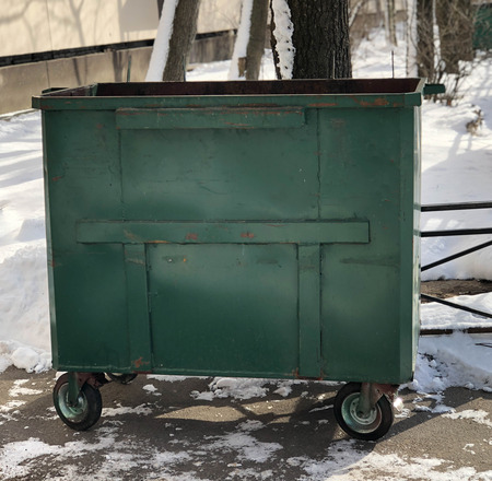 the trash can is on the street