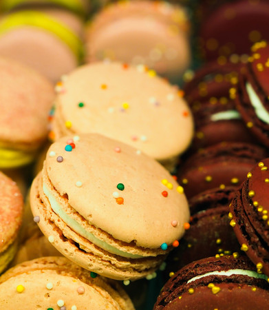 bright cakes and macaroons in the bakery windowの写真素材